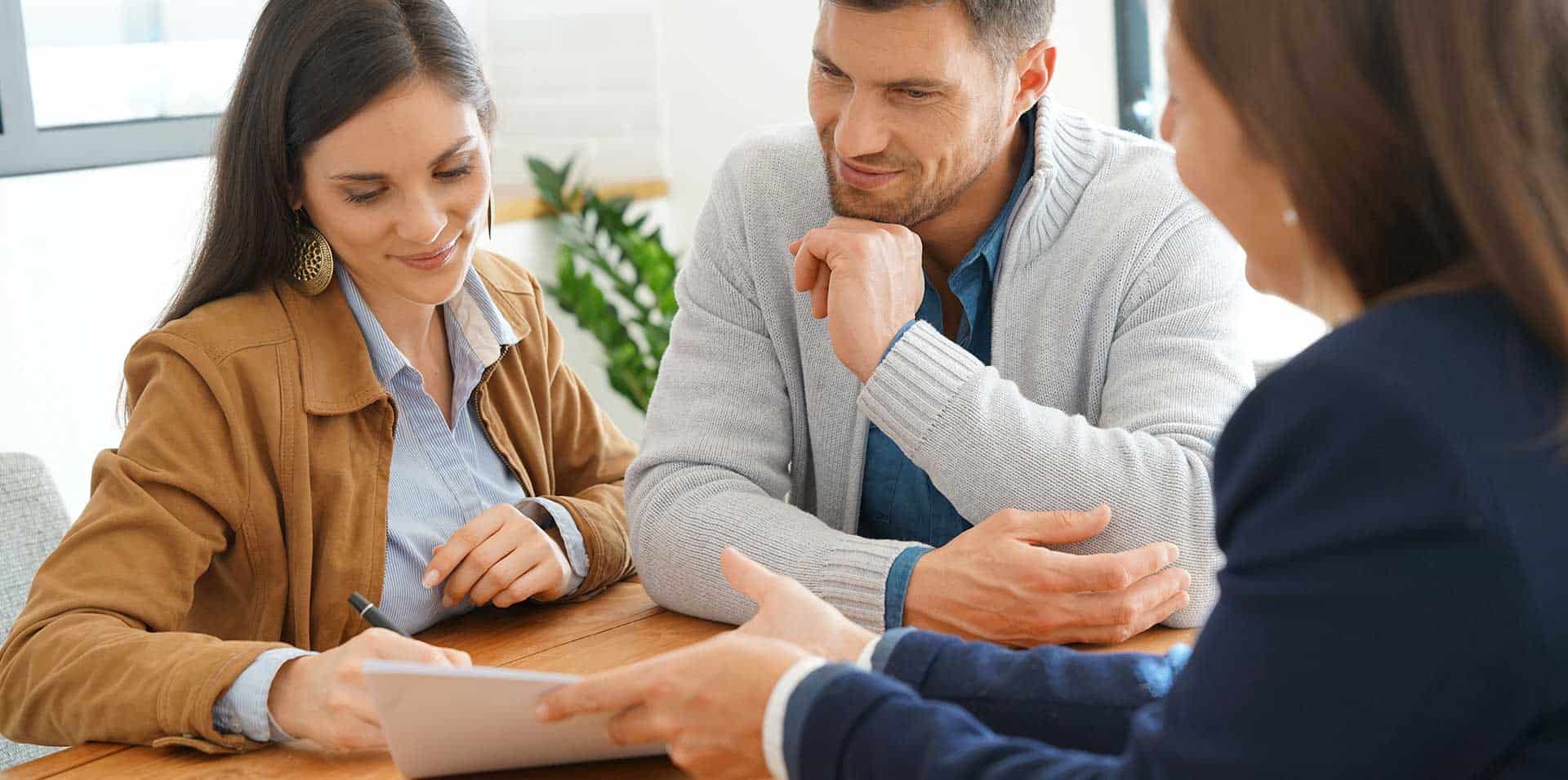 Couple talking with a mortgage correspondent