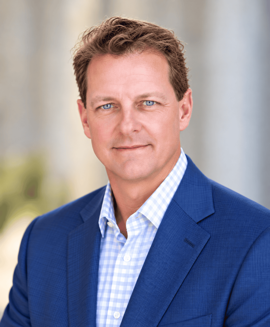 Jeff Weston, a professional financial advisor at GMFS Partners, is pictured in a business portrait. He is wearing a blue suit and white checkered shirt, standing against a neutral background.