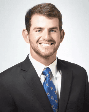 Professional portrait of a smiling man in a suit and tie, representing trust and expertise in financial services.